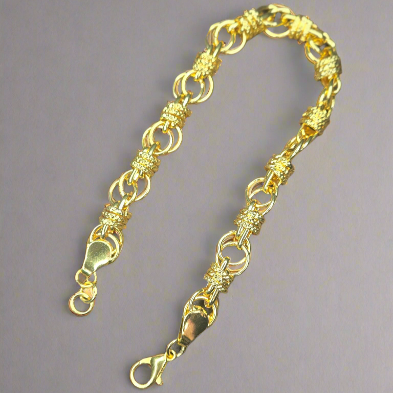 Gold bracelet on a gray background