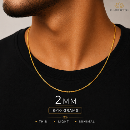A close-up of a man's neck and chest wearing a thin gold chain necklace. The image includes text overlays stating '2 MM', '8-10 GRAMS', and 'THIN • LIGHT • MINIMAL', with a 'UNIQUE JEWELS' logo in the top right corner.