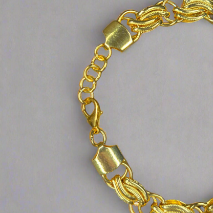 Gold bracelet on a gray background